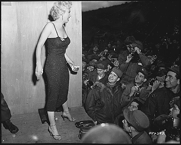 Marilyn Monroe, motion picture actress, appearing with the USO Camp Show, "Anything Goes," poses for the shutterbugs after a performance at the 3rd U.S.Infantry Division area., 02/17/1954