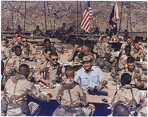 Photograph of President George H. W. Bush Enjoying Thanksgiving Dinner with Troops, 11/22/1990 29-0059a