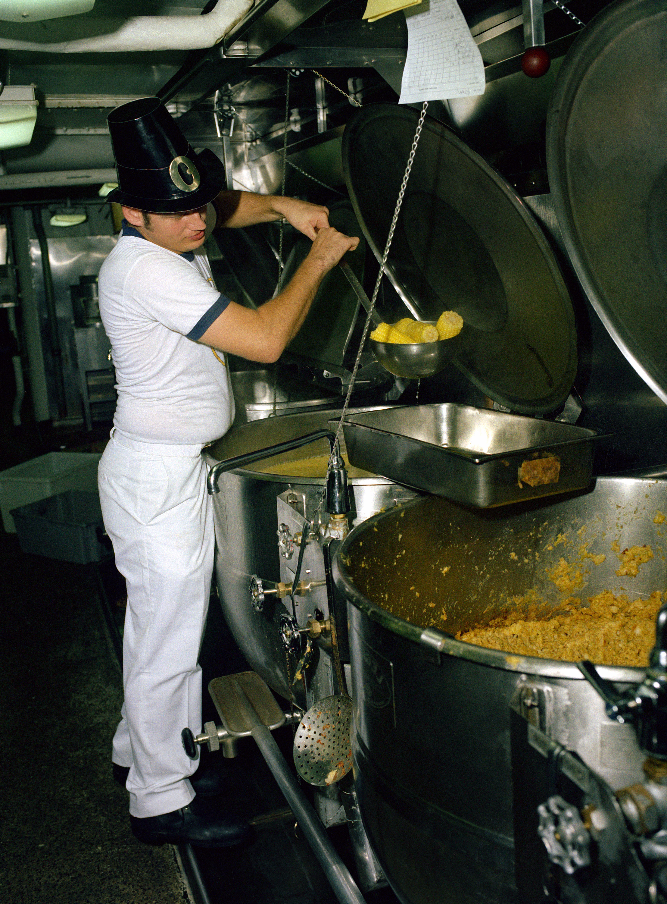 A mess management specialist helps prepare Thanksgiving dinner aboard the nuclear-powered aircraft carrier USS CARL VINSON (CVN 70), 11/24/1984 DN-SC-85-12223